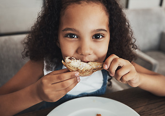 Image showing Lunch, portrait and child eating chicken in the dining room at a party, dinner or event at home. Hungry, happy and girl kid enjoying food or meal at the table for snack, hunger or craving at a house.