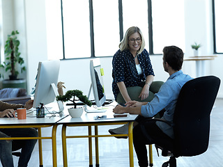 Image showing Happy business people, friendly conversation and talking in office, agency and startup company. Woman, man and employees speaking with happiness, teamwork and planning discussion for collaboration