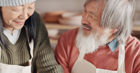 Image showing Pottery, creative and senior couple talking about art with hug and kiss together in a studio class. Elderly Asian man and woman hugging with love while learning and working with clay on a date