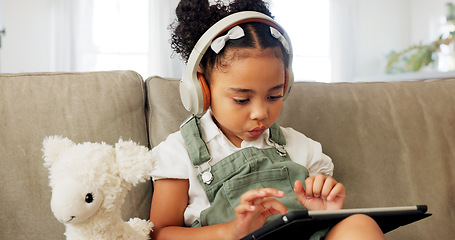 Image showing Tablet game, headphones and relax child gaming, having fun or play online games on mobile device or digital tech app. Kid entertainment, youth lifestyle and young gamer girl playing on ui touchscreen