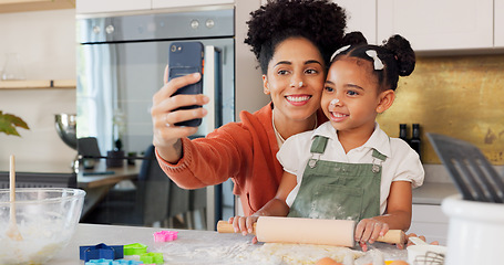 Image showing Mother, girl and phone selfie while cooking in kitchen, bonding and having fun. Learning, baking and mom, kid and 5g mobile for social media, picture or online post with victory hands or peace sign
