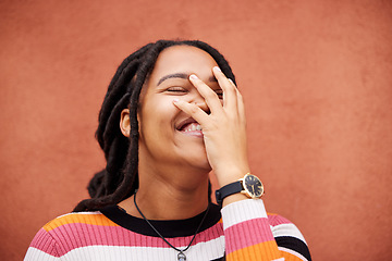 Image showing Happy, laughter and freedom with a black woman on an orange background outdoor for joy or humor. Funny, laugh and smile with an african american person laughing or joking against a color wall