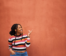 Image showing Mockup, pointing or black woman with marketing, product placement or branding space on wall background. Smile or African gen z girl advertising discount deal, sales offer or promotion announcement