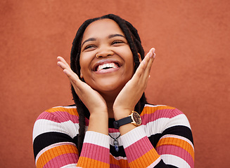 Image showing Happy, laugh and freedom with a black woman on an orange background outdoor for joy or humor. Funny, laughter and smile with an african american person laughing or joking against a color wall
