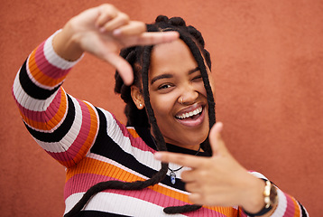 Image showing Finger framing, portrait and black woman on background for profile picture in Nigeria. Face, happy female and hands frame perspective, selfie and vision of happiness, smile and photography in studio