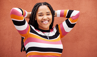 Image showing Relax, happy and portrait of a black woman by a wall in the city while on a vacation with freedom. Adventure, smile and African female with a happiness, joyful and carefree mindset in town on holiday