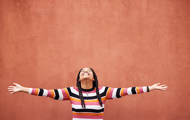 Image showing Black woman, open arms and wall background with space for mock up with smile, happiness and excited in city. Young gen z girl, outdoor and happy with mockup, fashion and palm with product placement