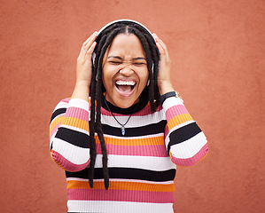 Image showing Loud music, headphones and black woman isolated on orange wall singing, wow and excited for gen z subscription. African person or happy youth listening to 5g audio technology or streaming services