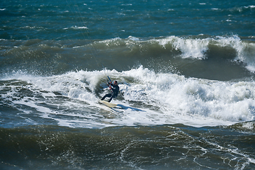 Image showing Kitesurfer riding ocean waves