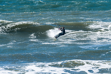 Image showing Kitesurfer riding ocean waves