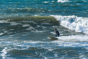 Image showing Kitesurfer riding ocean waves