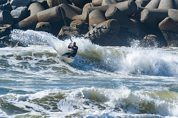 Image showing Kitesurfer riding ocean waves