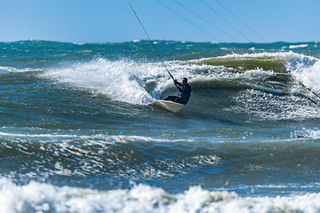 Image showing Kitesurfer riding ocean waves