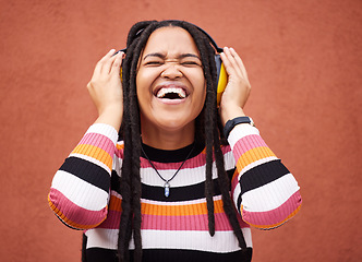 Image showing Black woman, music headphones and smile by wall in city for walk, adventure or happy laughing for comedy. Young gen z girl, audio streaming or comic podcast on website, internet or happiness in metro