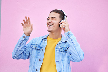 Image showing Headphones, man and happy dance on pink background, wall backdrop or studio mockup. Excited guy listening to music, sound and streaming audio media with freedom, smile and hearing radio for dancing