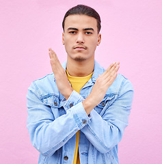 Image showing No, stop and portrait of a man with hands as a sign isolated on a pink studio background. Angry, caution and serious person with a rejection, decline and problem gesture with arms on a backdrop