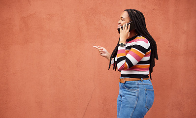 Image showing Happy black woman, phone call and smile on wall background with happiness, conversation and mockup space. African female talking on mobile, color mock up and smartphone communication with technology