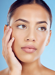 Image showing Skincare, beauty and woman in a studio with a natural, organic and cosmetic facial treatment. Self care, cosmetics and female model from Brazil with a fresh skin or face routine by a blue background.