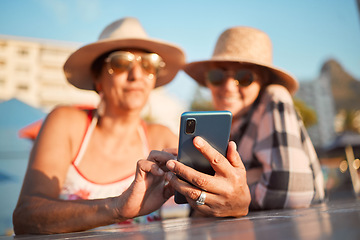 Image showing Senior, friends and phone for selfie, internet or search on vacation, break or summer holiday on blue sky background. Elderly, women and profile picture photo at an outdoor restaurant while traveling