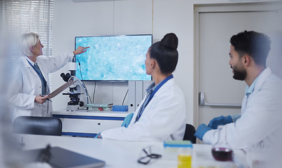 Image showing Presentation, science and scientist speaker in the laboratory meeting, training or seminar. Innovation, leadership and senior female researcher presenting discovery to her team with technology in lab