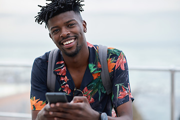 Image showing Black man, travel and portrait with smartphone and outdoor with communication, adventure at beach and backpacking. Holiday, happy and chat, check social media or post with 5g, technology and vacation