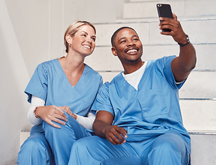 Image showing Healthcare, doctors and selfie in hospital, smile and fun together, bonding or achievement. Medical professionals, woman or black man with smartphone, picture for memories or in clinic with happiness