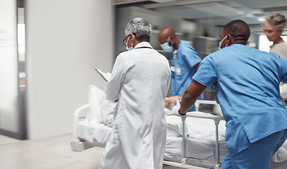 Image showing Busy, healthcare and doctors rush with patient, surgery and ready for procedure in hospital. Fast team, medical professional and staff with emergency, accident and health with wellness and nurses