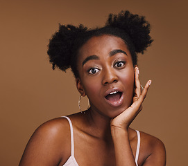 Image showing Beauty, skincare and portrait of shocked black woman with hand in face isolated on brown background. Surprise, wow and facial cosmetics or natural makeup for healthy, glowing skin on model in studio.