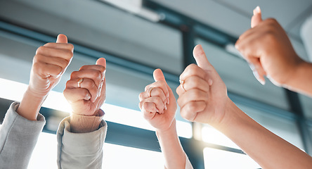 Image showing Hands, thumbs up and collaboration with a business team in celebration together at the office from below. Winner, teamwork or gesture with a man and woman employee group celebrating at work closeup
