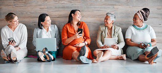 Image showing Collaboration, technology and communication with a business team sitting on the floor in their office for work. Teamwork, diversity and corporate design with a woman employee group working together