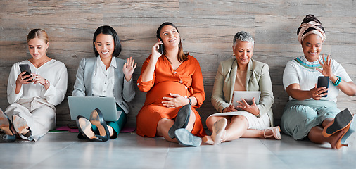 Image showing Teamwork, technology and diversity with a business team sitting on the floor in their office for work. Collaboration, communication and corporate design with a woman employee group working together