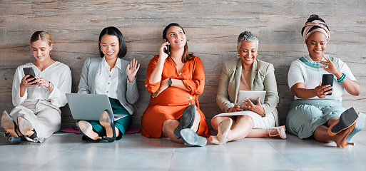 Image showing Collaboration, technology and diversity with a business team sitting on the floor in their office for work. Teamwork, communication and corporate design with a woman employee group working together