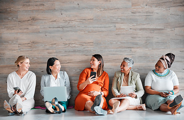 Image showing Collaboration, technology and mockup with a business team sitting on the floor, meeting in their office for work. Teamwork, diversity and corporate design with a woman employee group working together