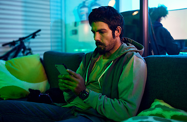 Image showing Man, hacking or phone typing in neon garage on cybersecurity app, software programming or phishing coding. Hacker, technology or planning virus code on night sofa in ideas, vision or virus fraud scam