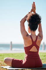 Image showing Fitness, black woman and meditation on yoga mat by beach for spiritual wellness or exercise in nature. Sporty female yogi back in warm up arm stretch for zen workout, relax or awareness in meditating