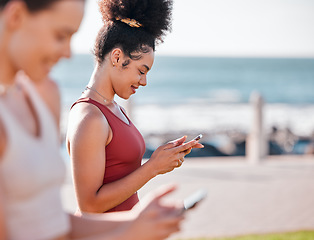 Image showing Fitness, women outdoor and smartphone for typing, break and resting with smile, training and wellness. Female athletes, girls and exercise with cellphone, happiness and workout for cardio and energy