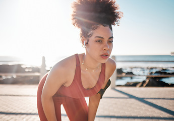 Image showing Exercise, music and tired with a black woman runner on the promenade for cardio or endurance training. Fitness, running and earphones with a sports person feeling exhausted during her workout