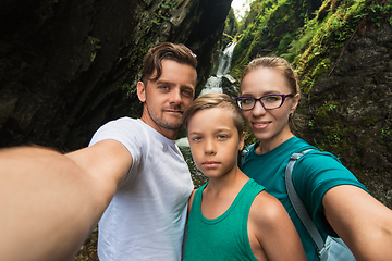 Image showing Selfie of family on the waterfall background