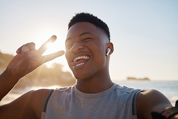 Image showing Selfie, fitness and peace with a black man on the beach for a cardio or endurance workout during summer. Portrait, hand sign and exercise with a male athlete or runner outdoor for marathon training