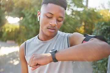 Image showing Fitness, man and watch checking time or performance after running exercise, cardio workout or training in nature. Sporty male runner looking a wristwatch for tracking or monitoring healthy exercising