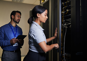 Image showing Server room, engineer teamwork and woman opening panel for maintenance or repairs at night. Cybersecurity, programmers and female with man holding tablet for software or networking in data center.