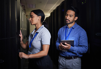 Image showing Engineer, server room teamwork and woman opening panel for maintenance or repairs at night. Cybersecurity, programmers and female with man holding tablet for software or networking at data center.