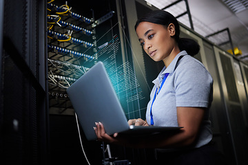 Image showing Laptop, network and data center with a black woman it support engineer working in a dark server room. Computer, cybersecurity and analytics with a female programmer problem solving or troubleshooting