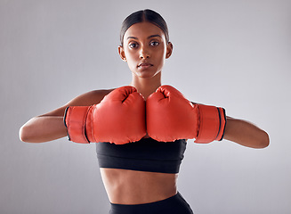 Image showing Boxing, hand gloves and portrait of woman in studio for sports exercise, strong muscle or mma training. Indian female boxer, workout and fight for impact, energy and warrior power in battle challenge