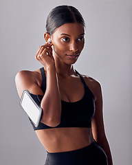 Image showing Fitness, music and woman in studio for exercise, wellness and advertising on grey background space. Workout, mockup and girl relax with podcast, audio for track for motivation while training isolated