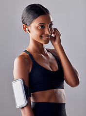 Image showing Studio, fitness and woman with music in exercise, wellness or advertising on grey background space. Workout, mockup and girl relax with podcast, audio or track for motivation while training isolated