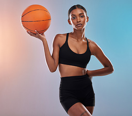 Image showing Portrait, basketball and black woman isolated on gradient background for workout, training and body goals. Young Indian athlete, person or model in studio with ball focus. exercise or cardio health