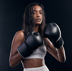 Image showing Boxer, fight and portrait of woman on black background for sports, strong focus or mma training. Female boxing, workout or fist gloves of impact, energy and warrior power for studio fitness challenge