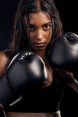 Image showing Boxing, gloves and portrait of woman on black background for sports, strong focus or mma training. Female boxer, workout or fist fight of impact, energy and warrior power for studio fitness challenge