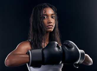 Image showing Portrait, woman and boxer with fitness, serious and ready for match, confident and dark studio background. Face, female athlete and lady with gloves, training or endurance for energy, strong or power